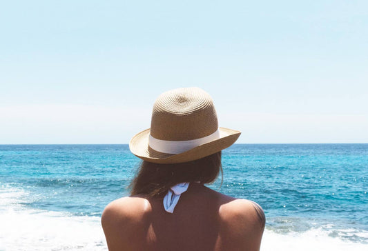 Woman on beach wearing hat